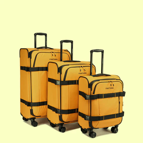 Set of three yellow rolling suitcases with telescopic handles and black trim on light background
