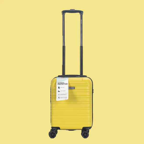 Yellow hard shell carry-on suitcase with telescopic handle and four wheels on yellow background